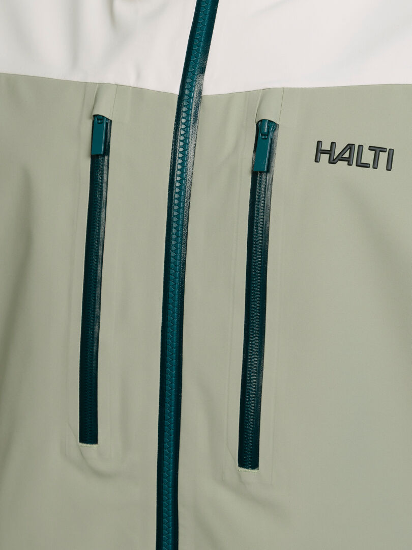 Close-up of a two-toned Rizle Unisex 3L DX Ski Jacket with two vertical zippered chest pockets.
