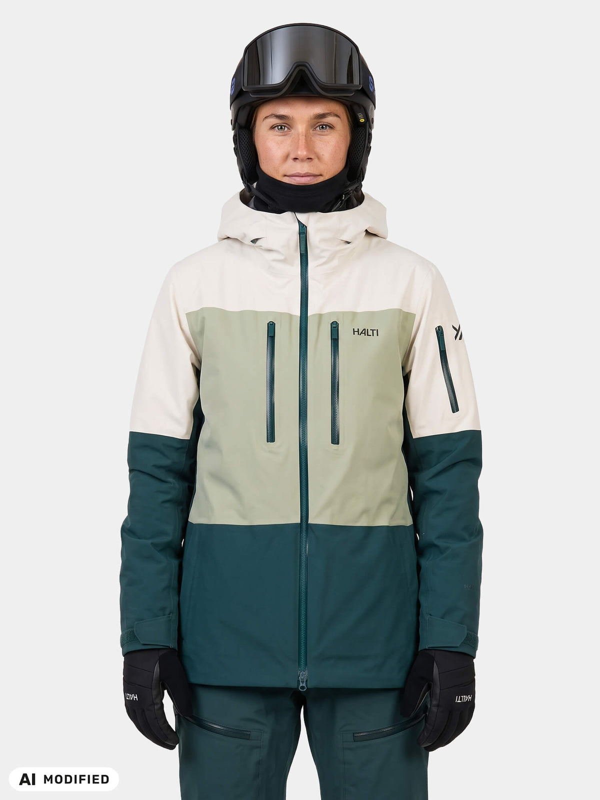 A person wearing a color-blocked Halti Rizle Unisex 3L DX Ski Jacket, helmet, and goggles.