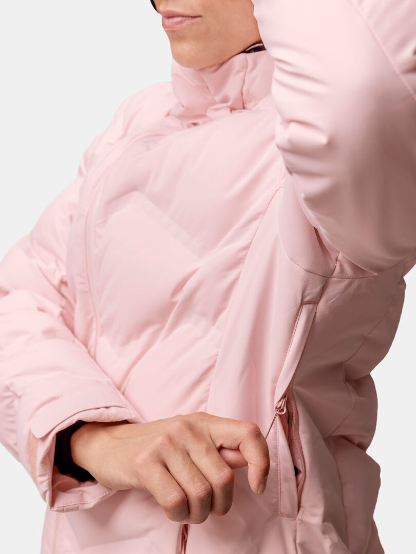 A woman unzips the underarm vent of the Halti Nordic Arcty II Ski Jacket, revealing the side zipper detail.