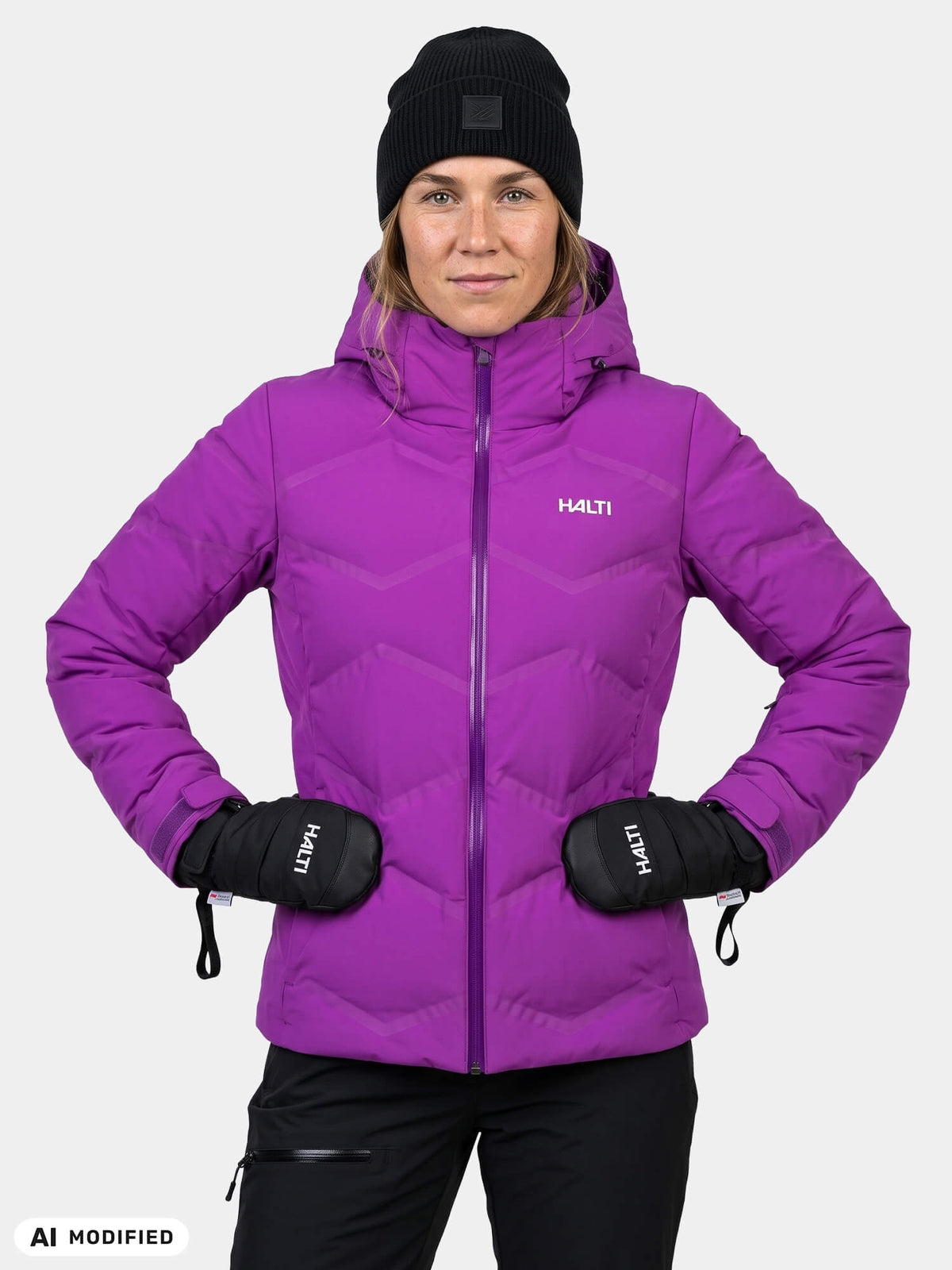 Woman in a purple Halti Nordic Arcty II Ski Jacket, black beanie, and black mittens.