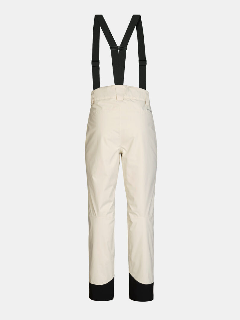 Back view of off-white Halti Carvey II DX Ski Pants Women’s with black suspenders and black ankle cuffs.