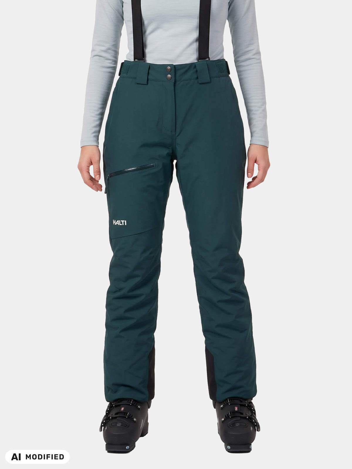 Dark teal Halti Carvey II DX Ski Pants women’s with black suspenders, worn over ski boots.