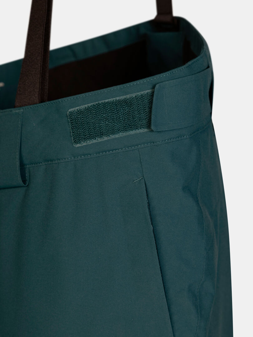 Dark green Halti Carvey II DX women’s ski pants with an adjustable hook-and-loop waist strap and black suspenders.