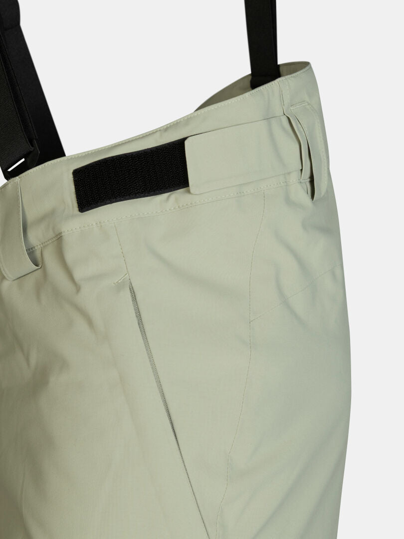 Light green Halti Carvey II DX ski pants featuring black suspenders and an adjustable waistband.
