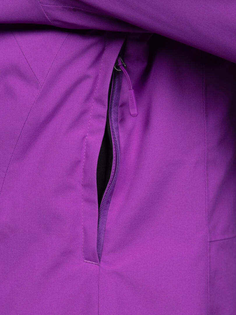 Close-up of a purple Halti Melvik DX Ski Jacket Women’s featuring a zippered side pocket with a branded pull tab.