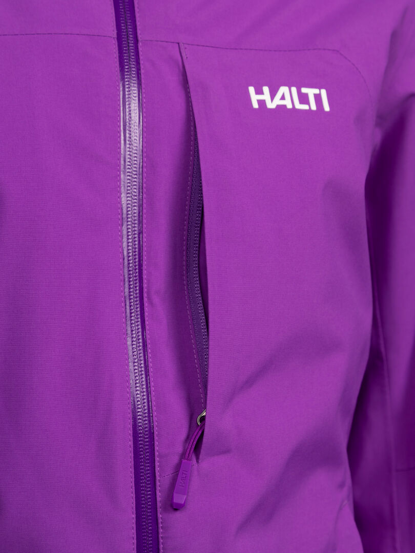 Close-up of a purple Halti Melvik DX Ski Jacket Women’s with a vertical zippered chest pocket and brand logo.