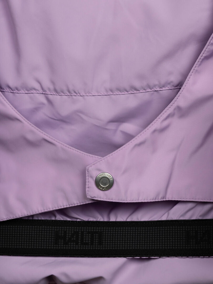 Close-up of Halti Ascloud Puffer Ski Jacket Women’s in light purple with a metallic snap and black strap partially visible.
