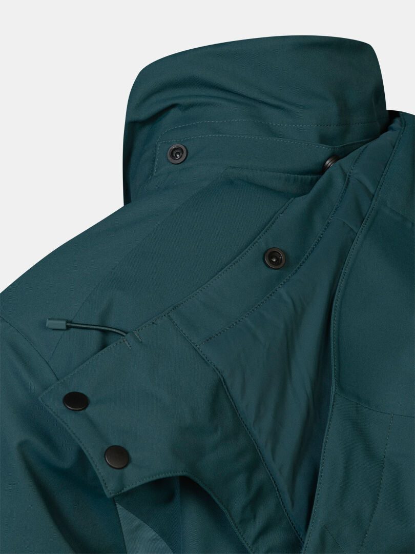 Dark green waterproof Halti Recier DX Ski Jacket Men’s featuring a snap-button collar and drawstring adjustment.