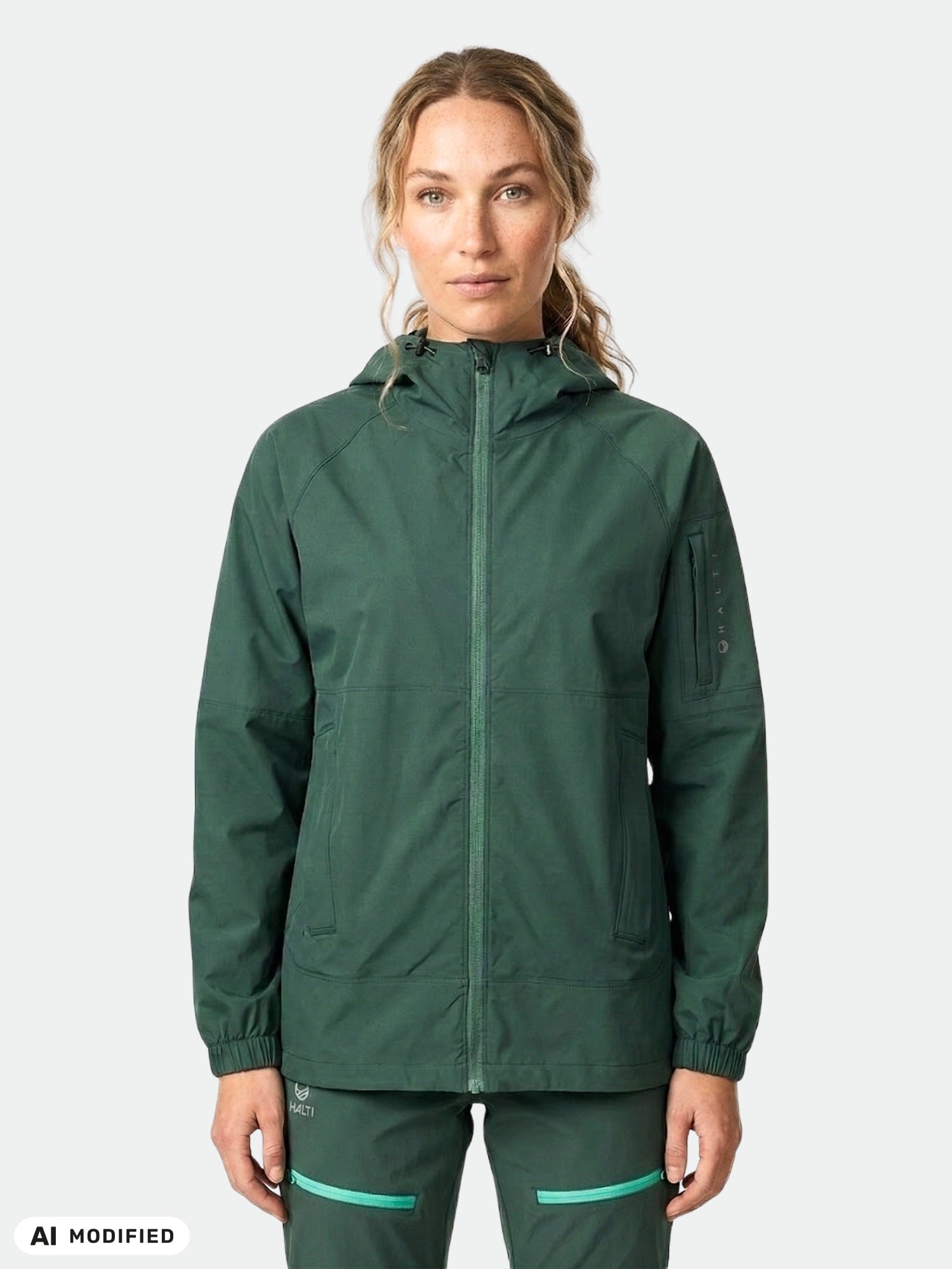 A woman models the Halti Pallas Women's Jogger Lite Jacket, standing forward against a plain background.