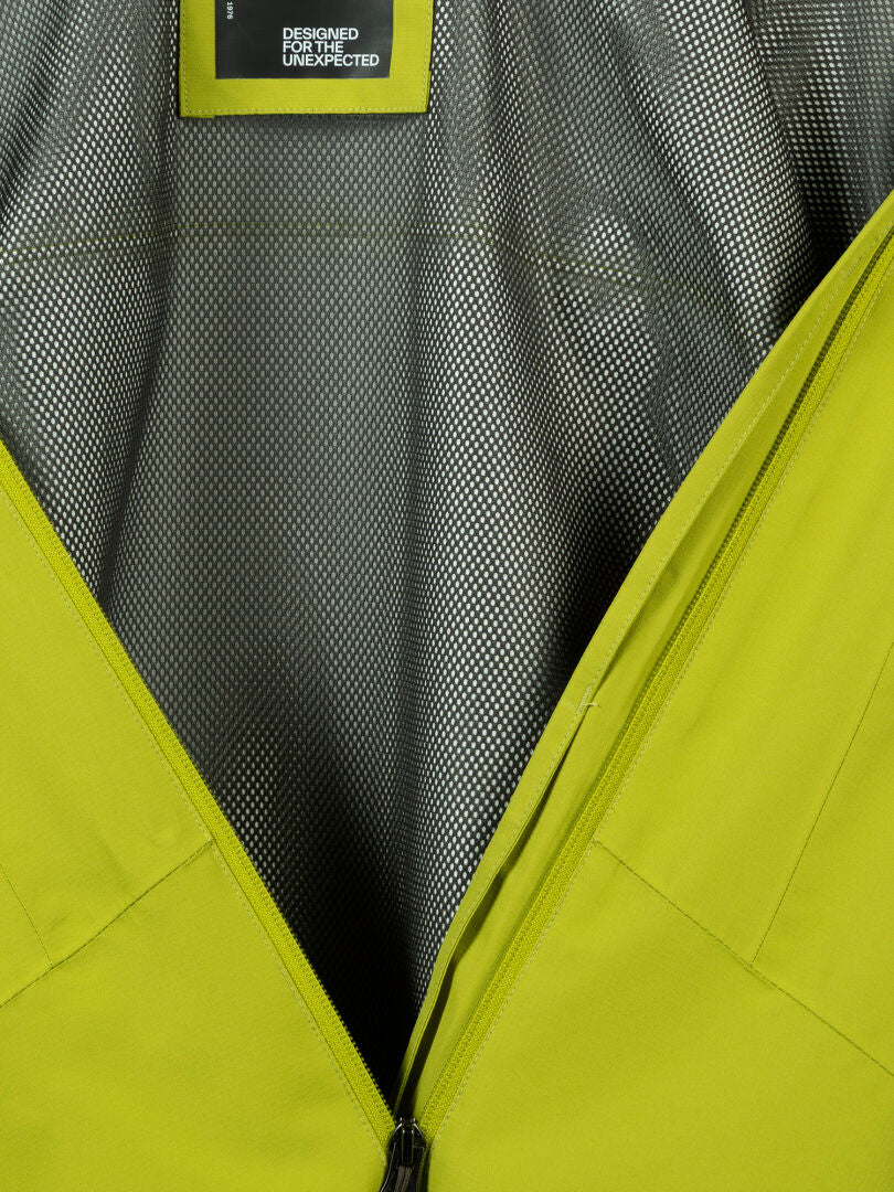 Close-up of Halti's Forter DX Shell Jacket Men’s, partially unzipped to reveal its gray textured lining—ideal for hiking.