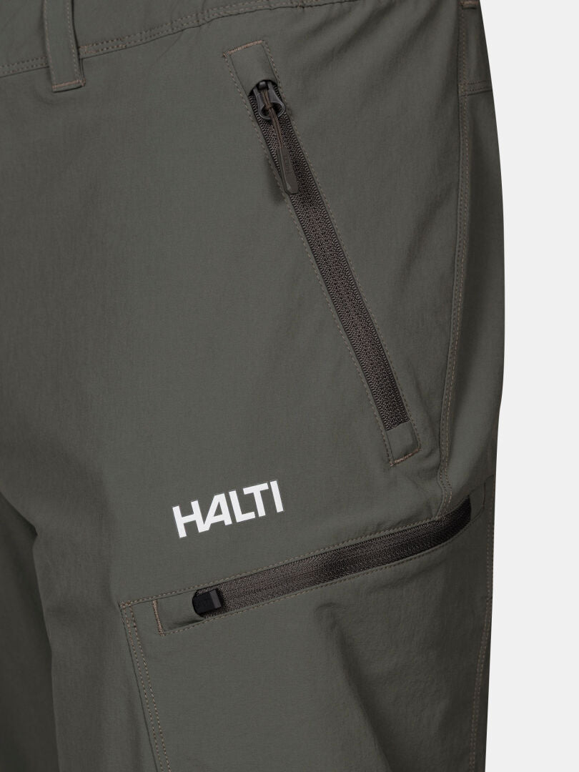 Close-up of Halti Pallas Evo X-stretch Men's Pants in gray, with zippered pockets and logo on the upper thigh.