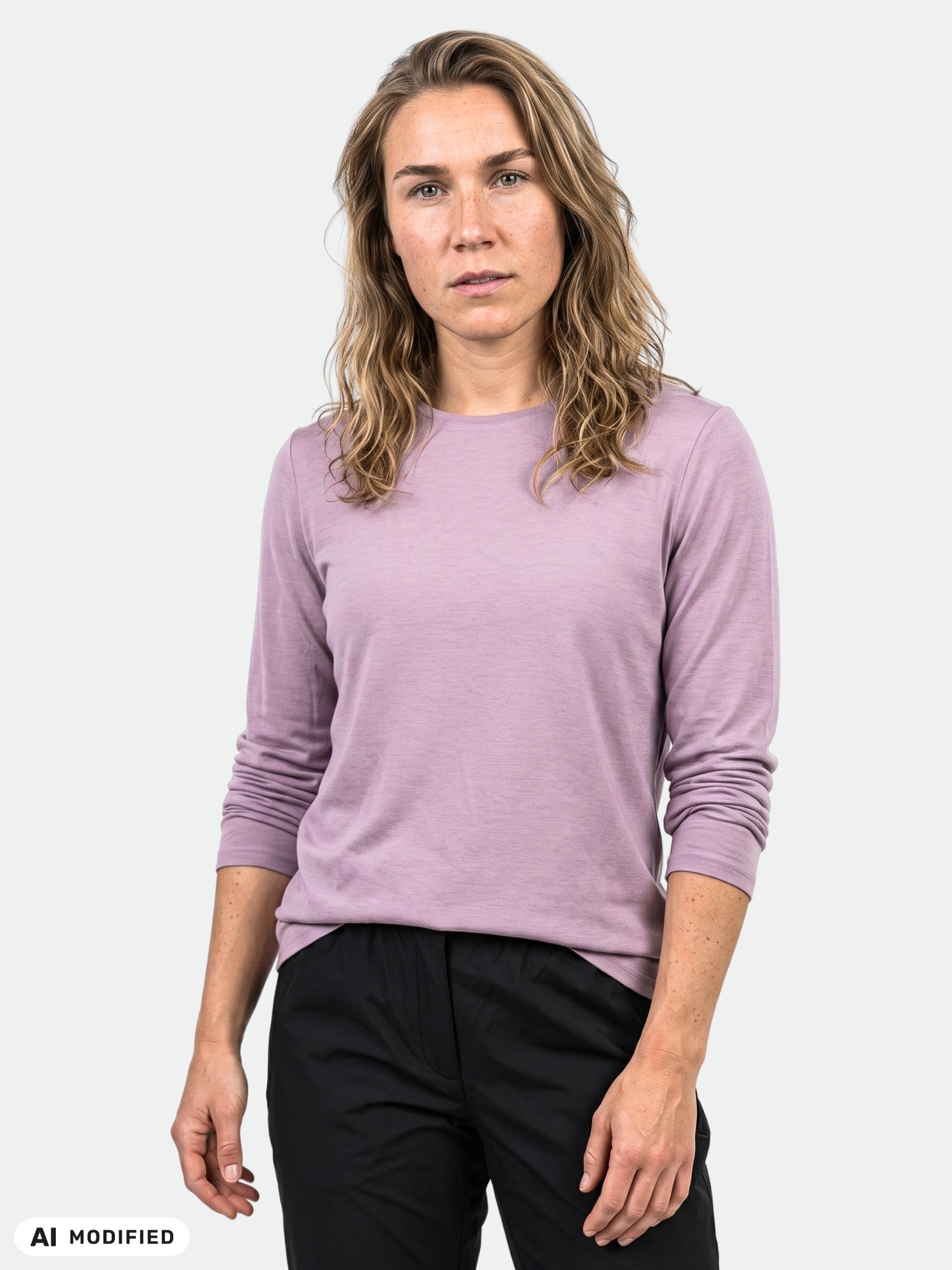 Model wears the Halti Tuntu II Long Sleeve Merino Shirt Women's in lavender and black pants, against a light gray background.