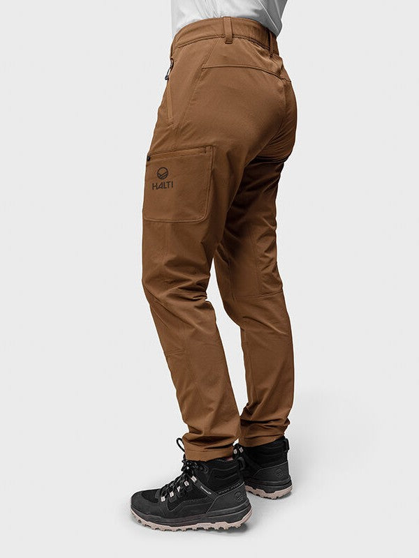 Woman wearing Halti Pallas Evo Brushed X-stretch Pants with side pocket and black hiking boots, shown from the back.