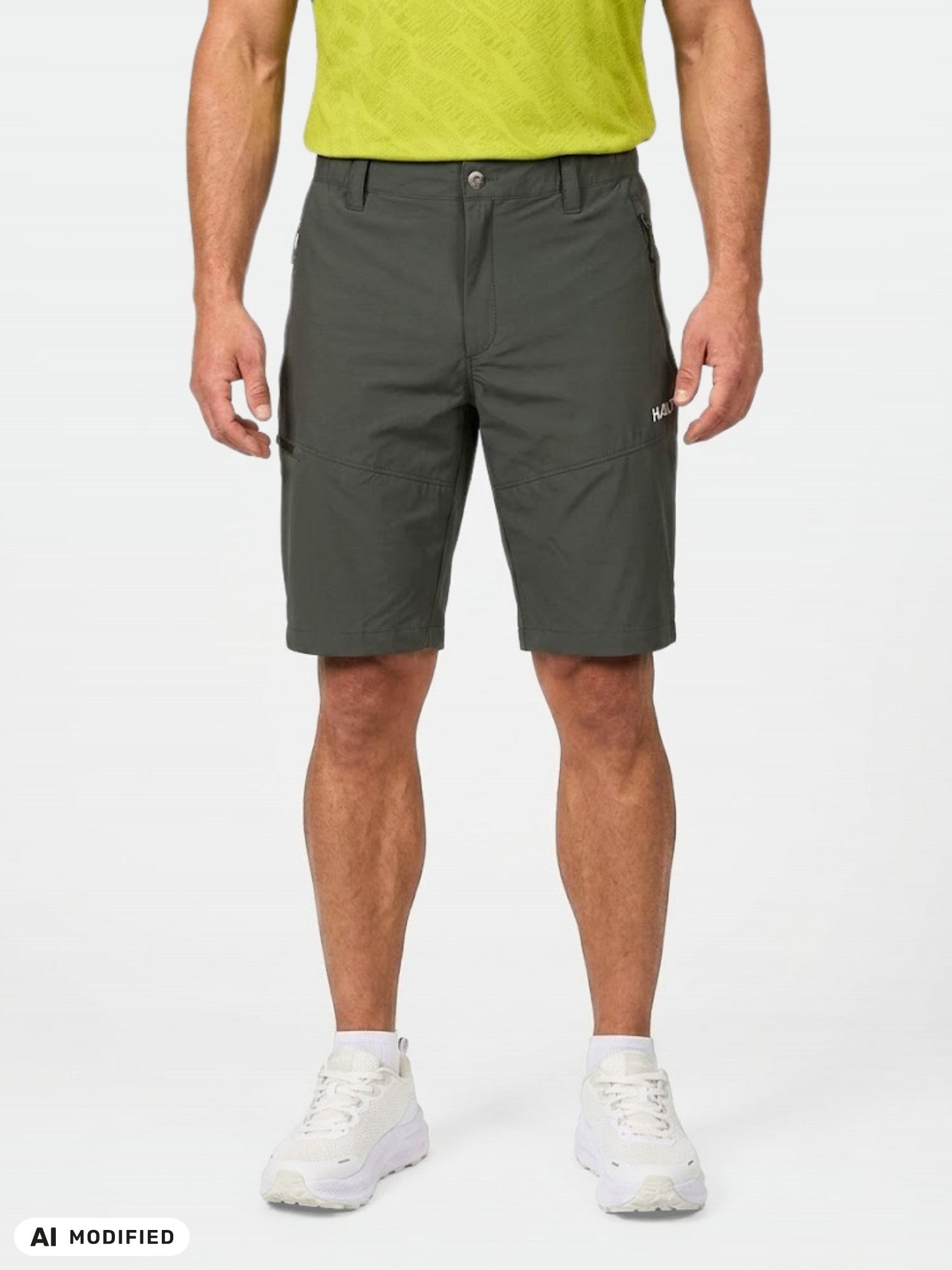 A man in a lime green shirt and Halti Pallas Cool X-stretch Shorts stands against a white background.