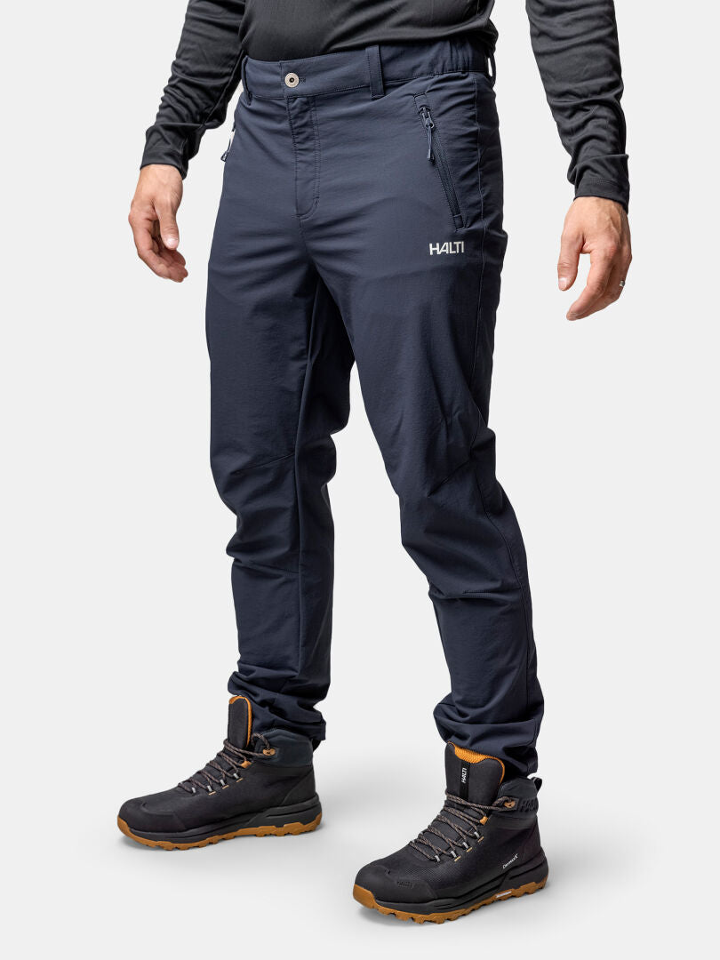 A person wears Halti Finholma X-stretch Pants and black boots against a plain white background.