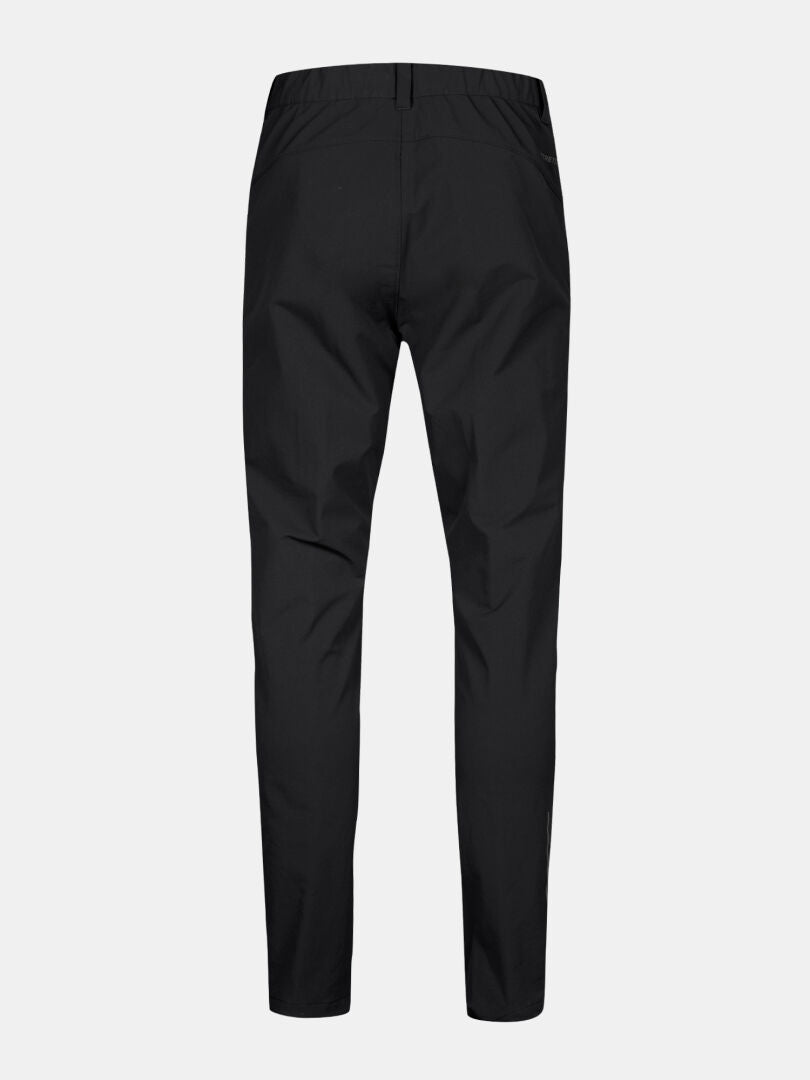 Back view of Halti Finholma X-stretch Men’s Pants in black with elastic waist and slim, tapered legs on grey background.