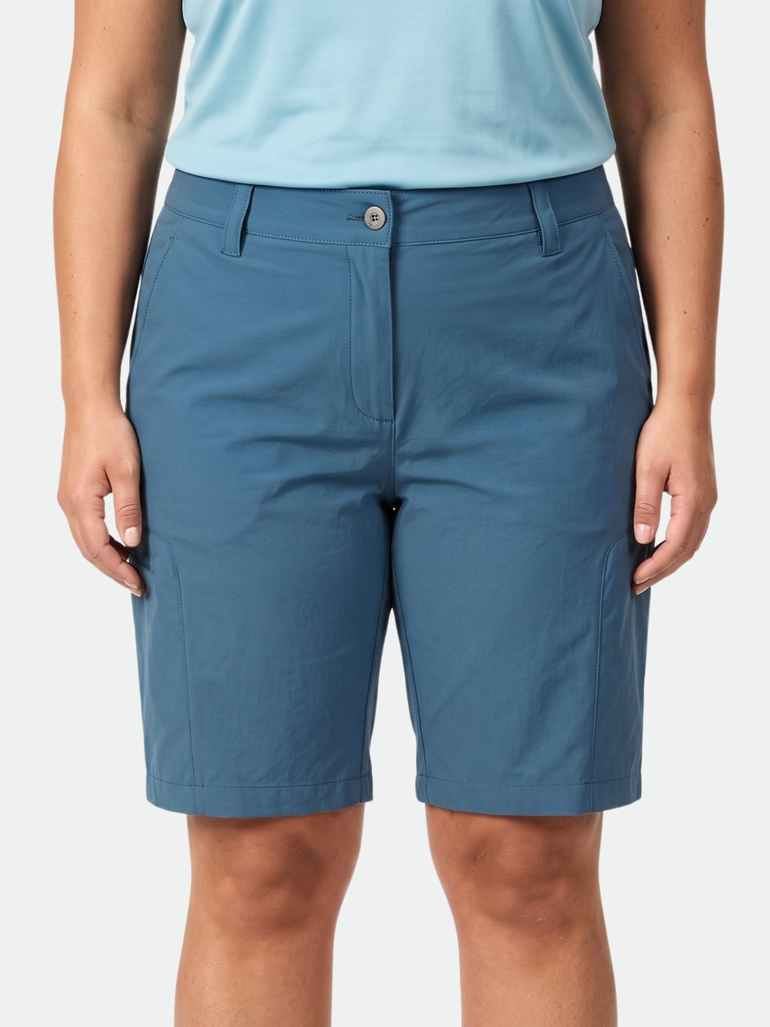 A woman wears Halti Pallas Cool Shorts Women's Plus and a light blue shirt, shown waist to knees, facing forward.