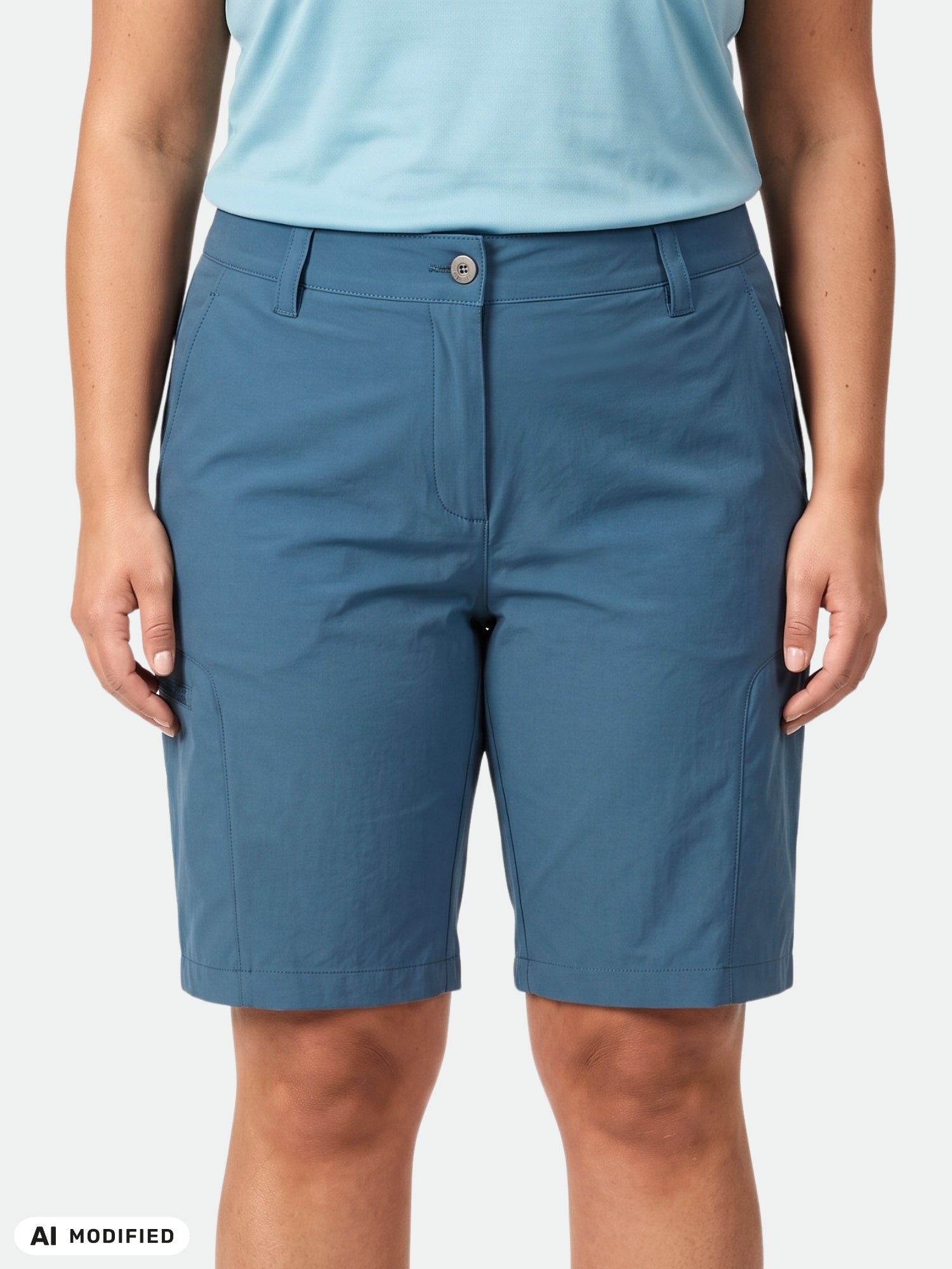 Woman in Halti Pallas Cool Shorts Women's Plus and a light blue shirt stands against a plain, light background.