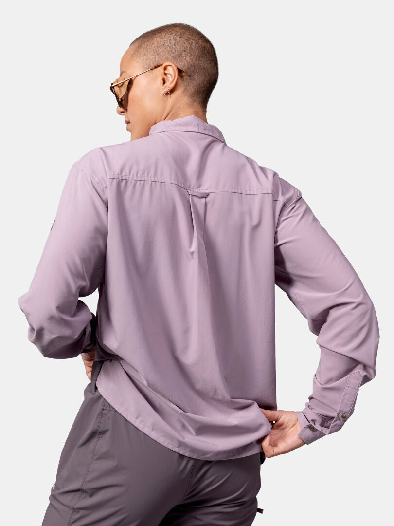 Person with a shaved head in sunglasses, seen from the back, wears Halti's Samoy Longsleeve Trekking Shirt for women.