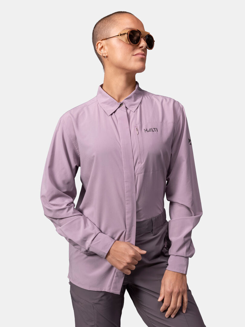 Person with short hair and sunglasses wears Halti Samoy Longsleeve Trekking Shirt Women's (UPF 90+) and gray pants.