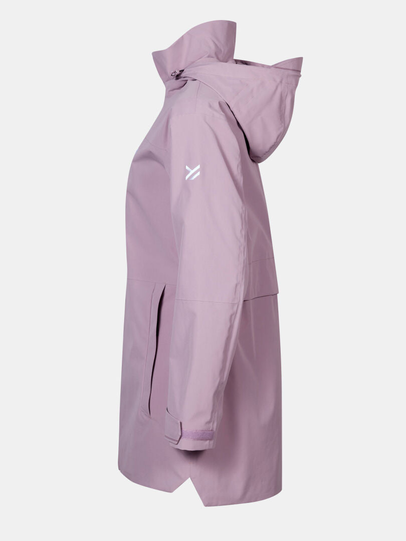 The Halti Valaja DX Parka Jacket Women's is light purple with long sleeves, a high collar, and a white logo on the upper left arm.