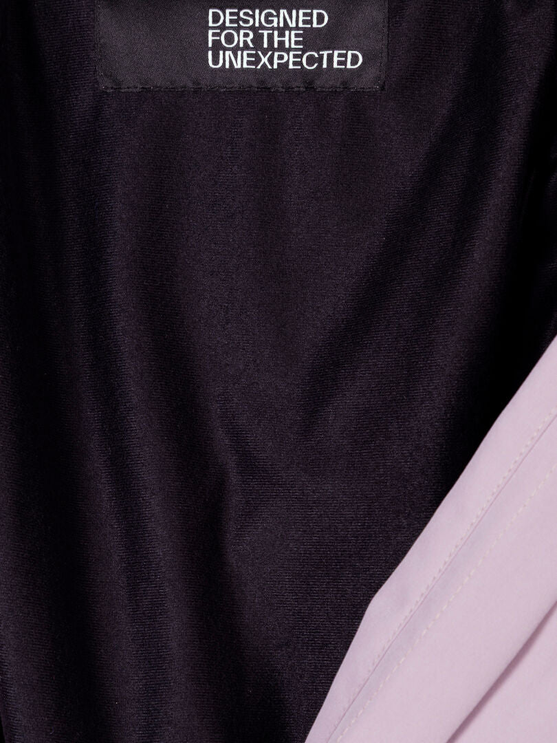 A close-up of the Valaja DX Parka Jacket Women's inner lining with a Halti label that reads DESIGNED FOR THE UNEXPECTED.