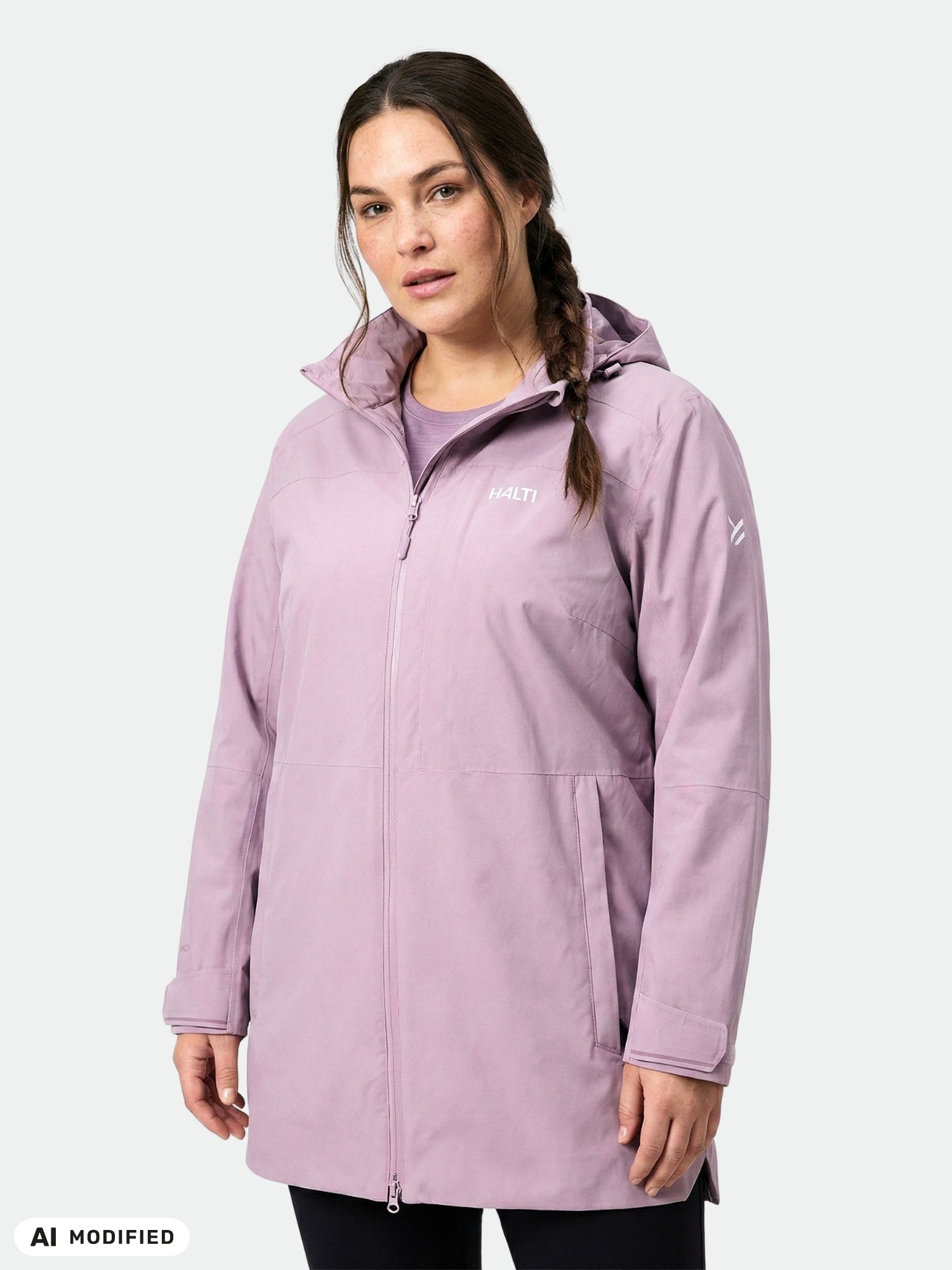 Woman wearing a light purple Halti Valaja DX Parka Jacket Women's Plus, standing against a plain light gray background.