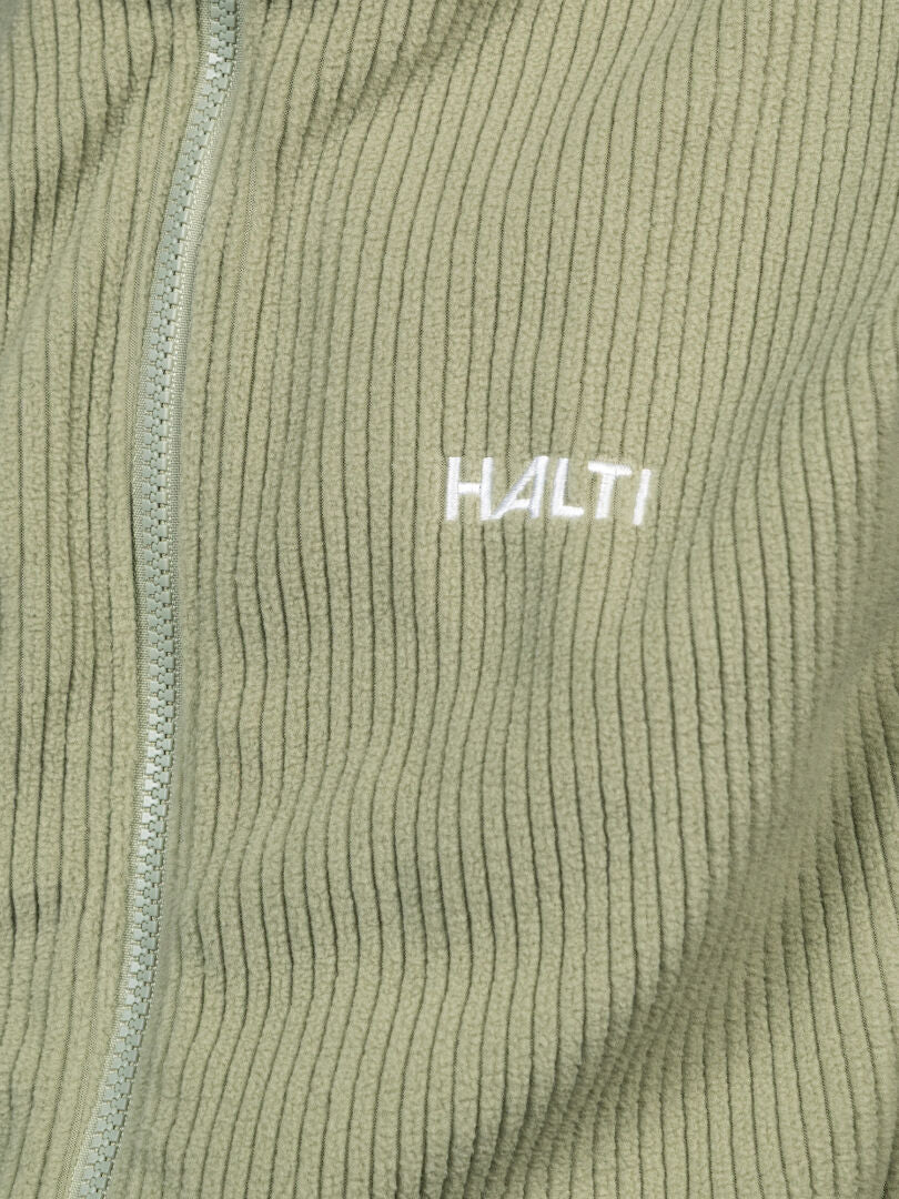 Close-up of a ribbed, light green Halti Loito 3-in-1 DX women’s jacket with zipper and white embroidered Halti logo.
