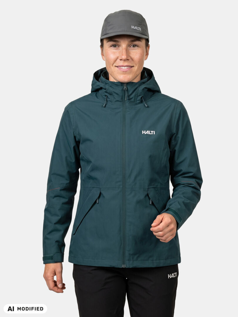 She wears a Halti Loito 3-in-1 DX Jacket for women with a matching cap and black pants, against a plain background.