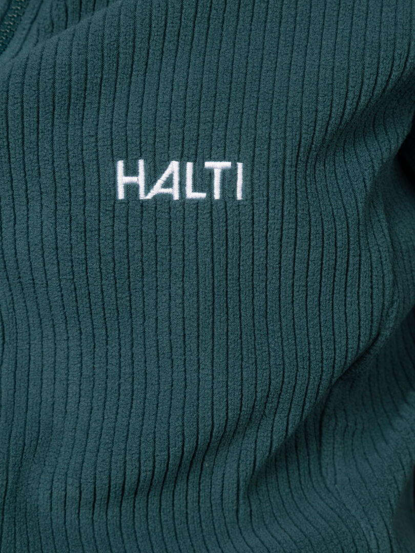 Close-up of a ribbed dark green Loito 3-in-1 DX Jacket Women’s with Halti embroidered in white.