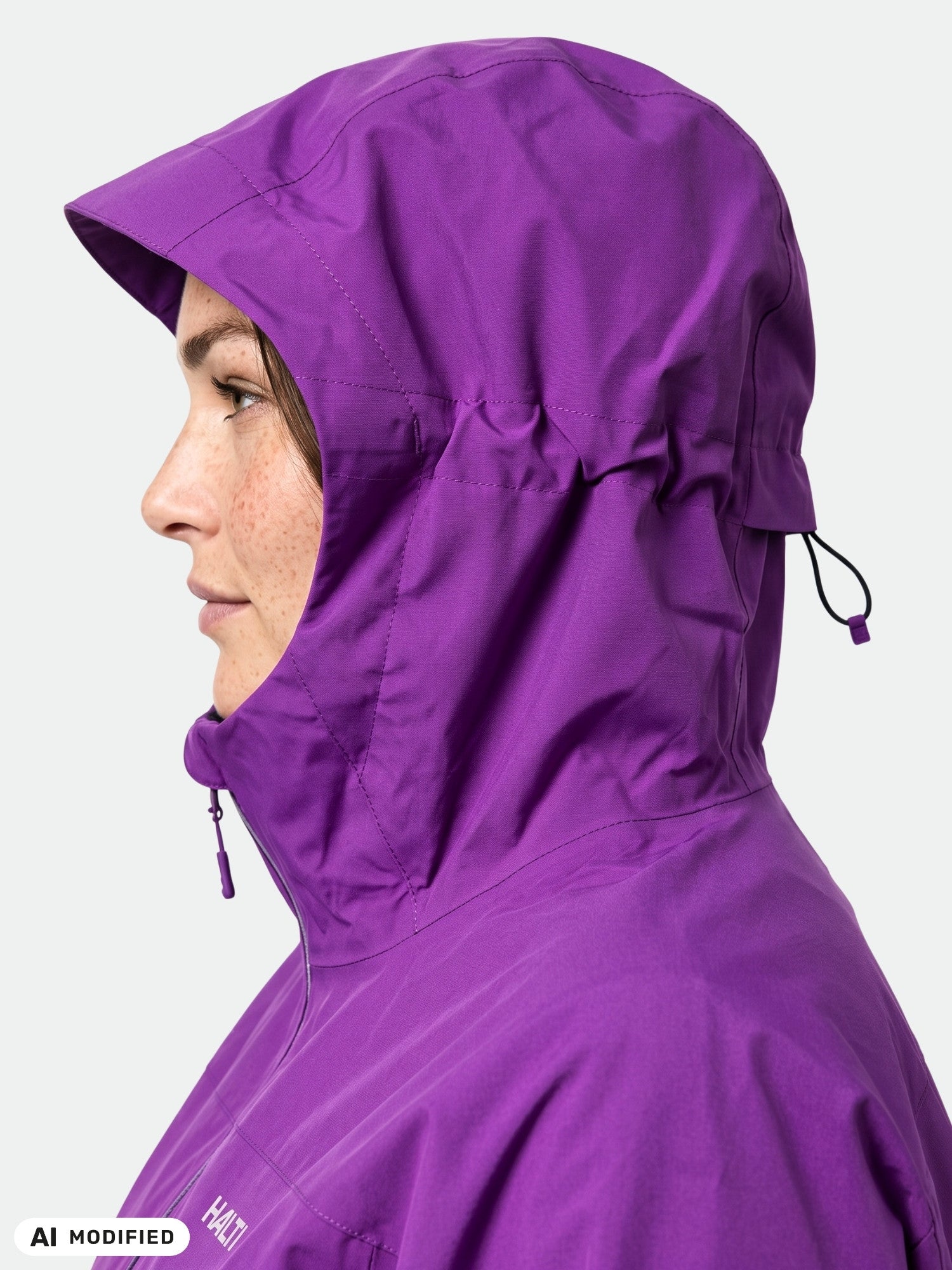 Woman in Halti Kaltimo DX Shell Jacket Plus, purple, shown in profile against a plain light background.