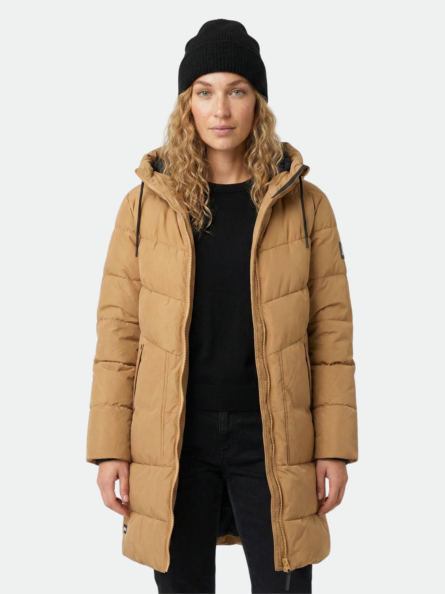 A woman wears the Halti Linjat Parka Jacket and a black beanie, standing facing forward against a plain background.