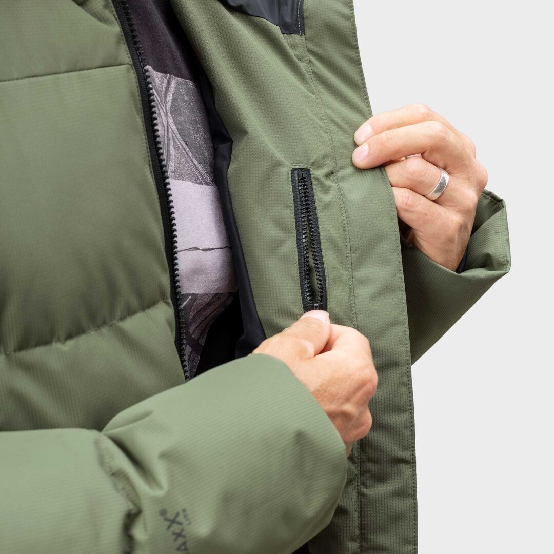A person unzips an inner pocket of the olive green Halti Linjat Parka Jacket Men's, revealing part of a shirt.