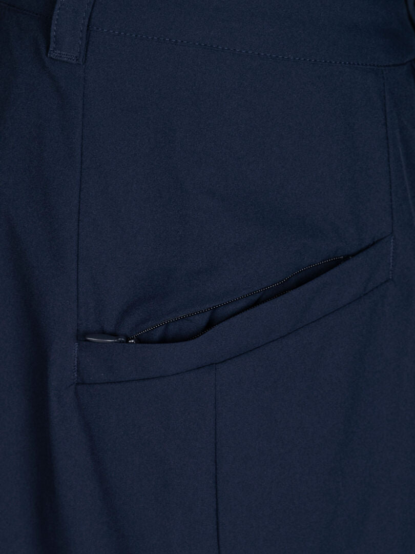 Close-up of Halti Drive X-stretch Skort Women's in navy blue, showing the pocket with a partially visible black zipper.