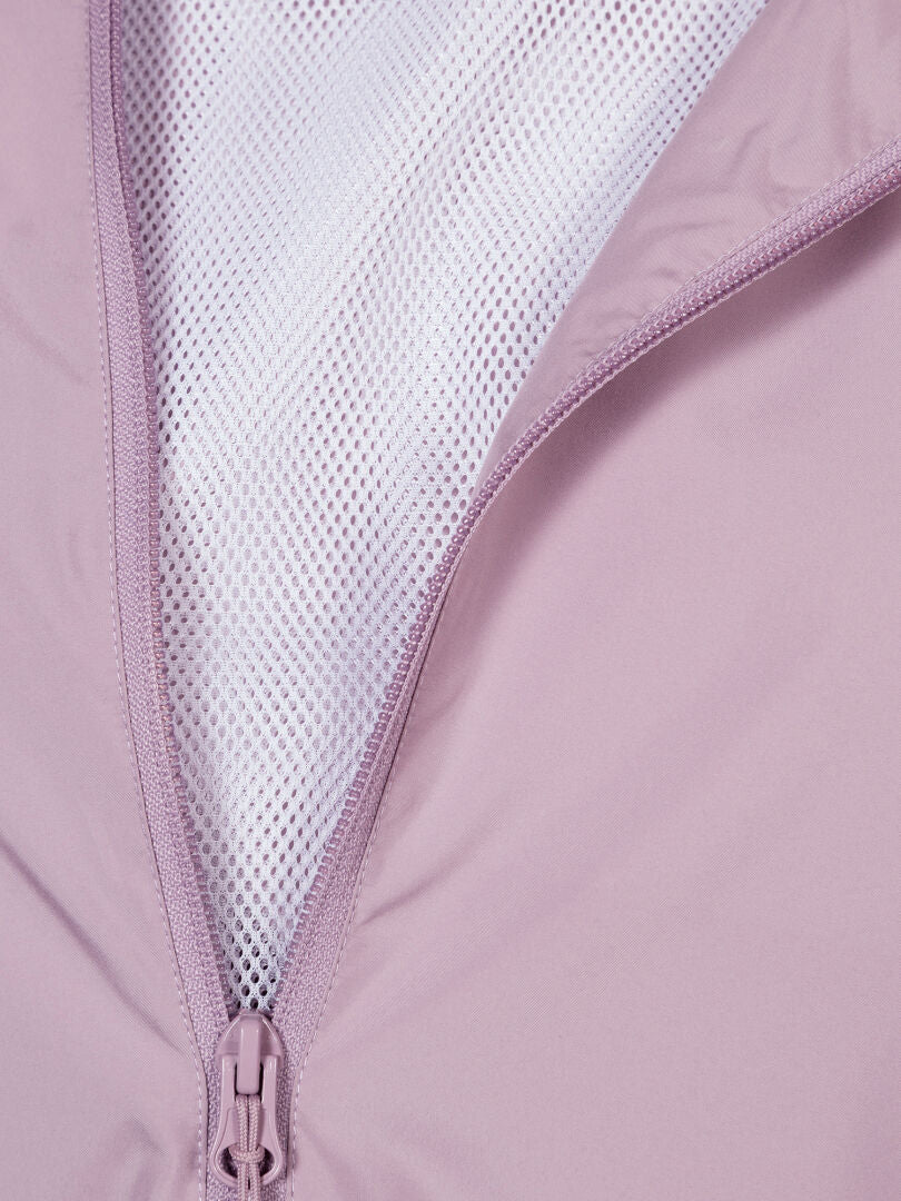 Close-up of the Halti Saime Windbreaker Jacket for women, featuring a light purple shell, white mesh lining, and windproof fabric.