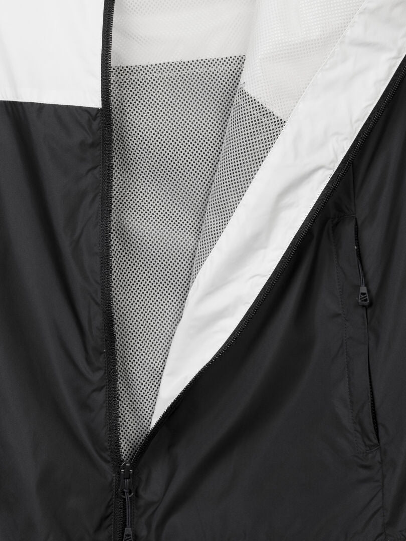 Close-up of the Halti Saime Windbreaker Jacket Men's, partially unzipped to show its mesh inner lining.