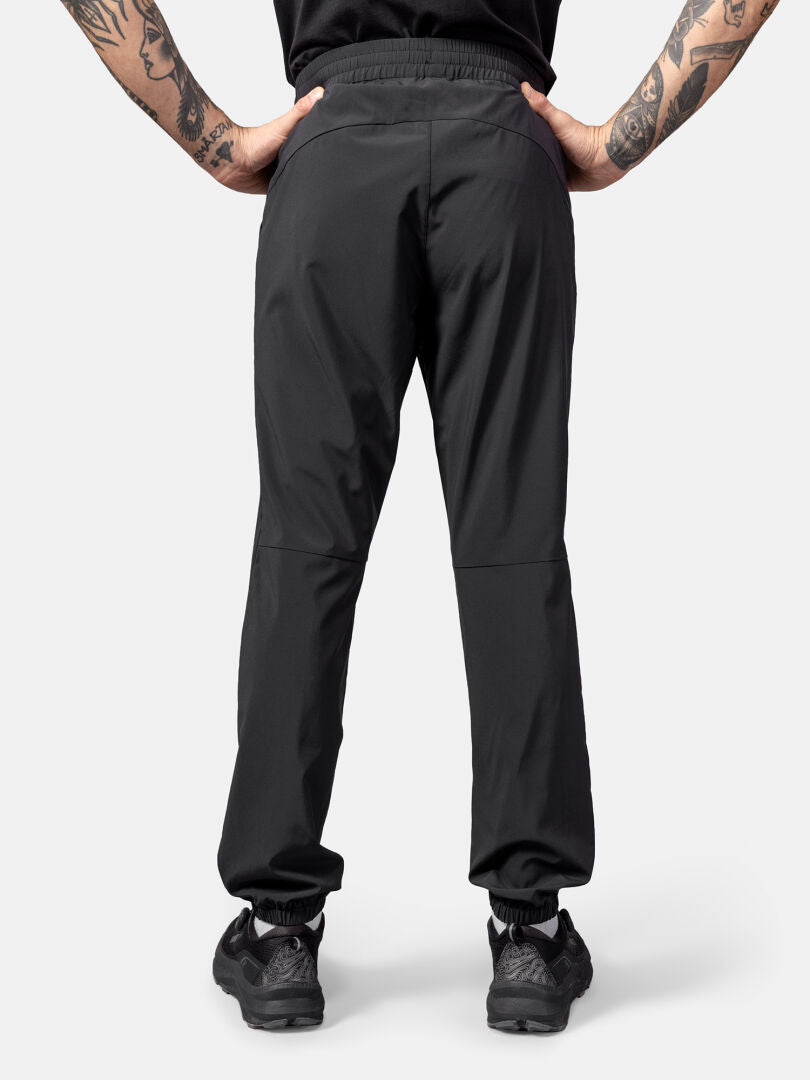Person wearing Halti Grets Jogger Pants for men, shown from the back with arm tattoos and UPF 50+ protection.
