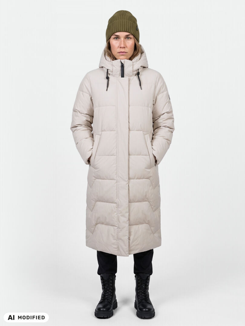 A person wears the Halti Brahe Puffer Long Winter Jacket, green beanie, black pants, and boots facing forward.