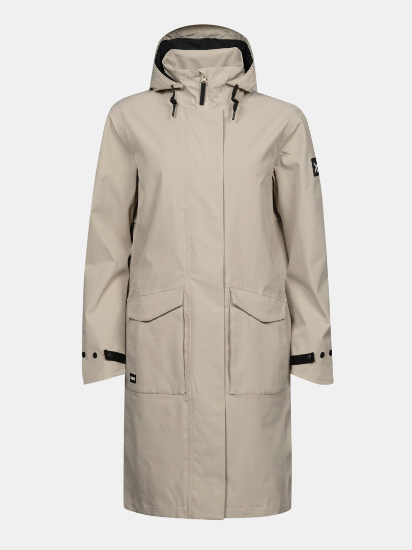Halti Tokoi II DX Parka: beige women’s raincoat with DrymaxX shell, front zip, 2 pockets, black trim on cuffs and hood.