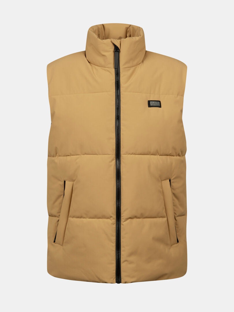 Halti Penger Classic Puffer Vest Men's: tan, wind-resistant, high collar, black zip, side pockets, logo patch on chest.