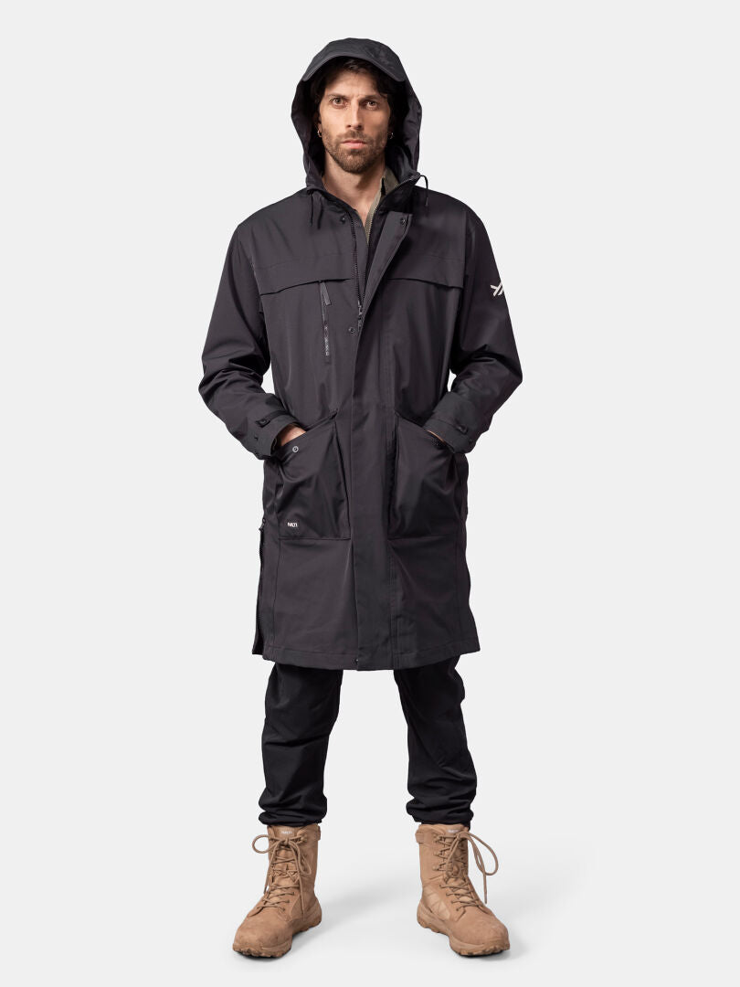 Man in Halti Tokoi II DX Parka Jacket, black pants, and tan boots stands facing forward against a plain background.