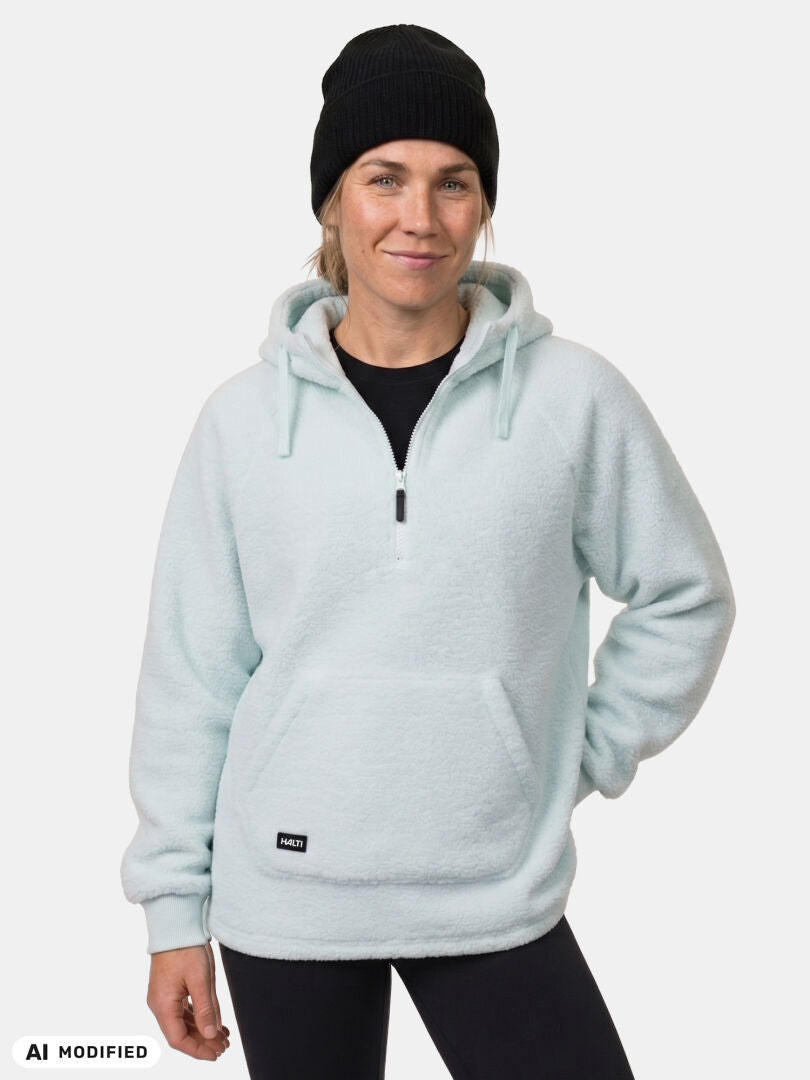 Model wears the Halti Lykky Fleece Pullover Women’s, black beanie, and pants, posed against a white background.