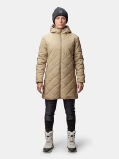 Person wearing the Halti Haapa Quilted Coat Jacket for women, black pants, gray beanie, and winter boots.