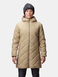 A woman wears the Halti Haapa Quilted Coat Jacket and a dark gray beanie, facing forward against a plain background.
