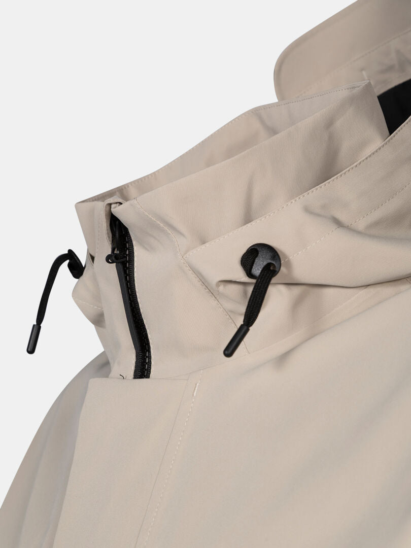 Close-up of Halti Tokoi DX Jacket Men's beige high collar with black zipper and adjustable black drawstrings.