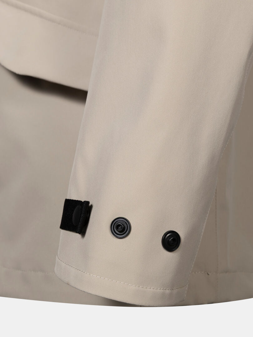 Close-up of Halti Tokoi DX Jacket Men's: beige waterproof sleeve with black snap buttons and adjustable cuff strap.