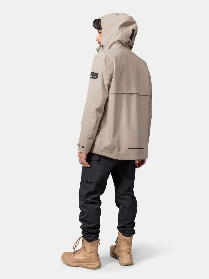 A person wears the Halti Tokoi DX Jacket Men's, black pants, and tan boots, facing away on a plain light background.