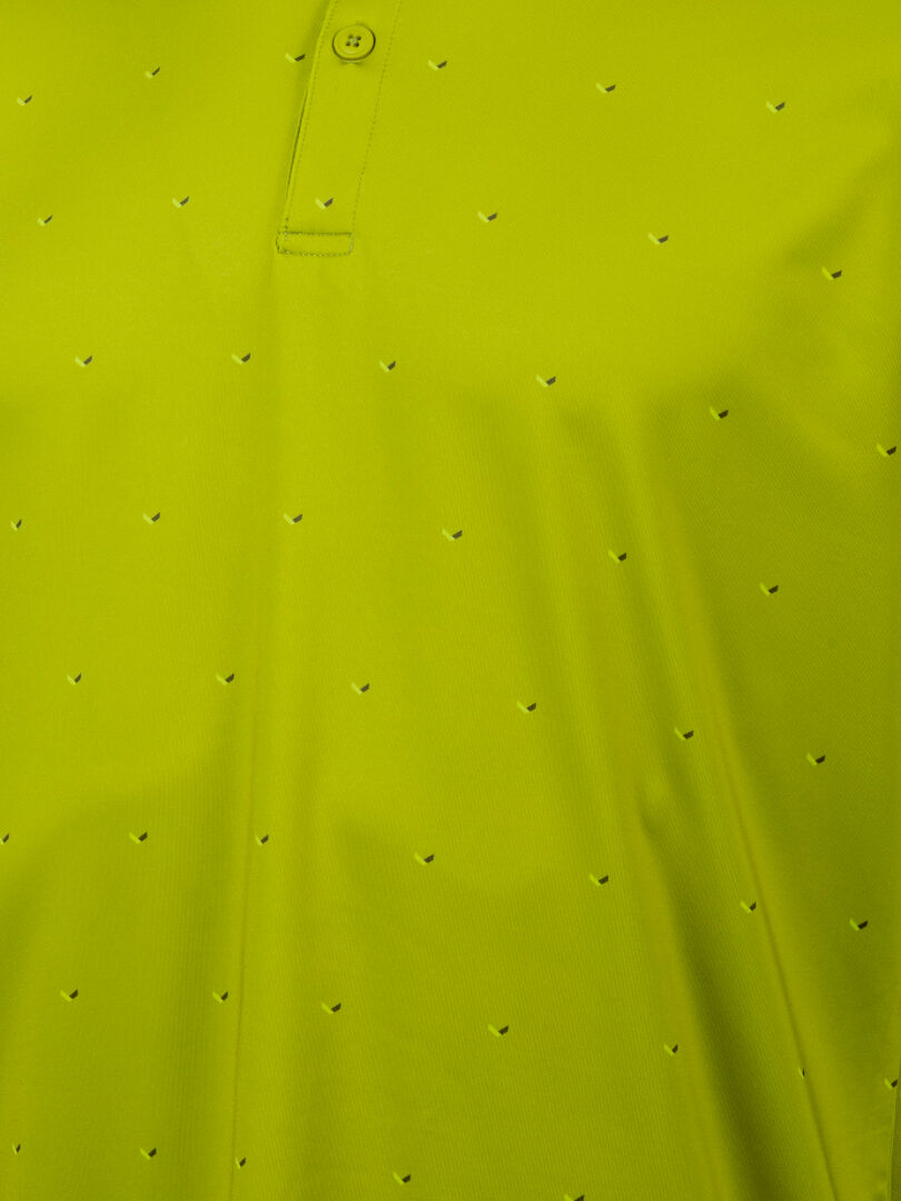 Close-up of the Halti Aridi Technical Polo Shirt Men's in yellow-green, showing breathable perforations and placket detail.