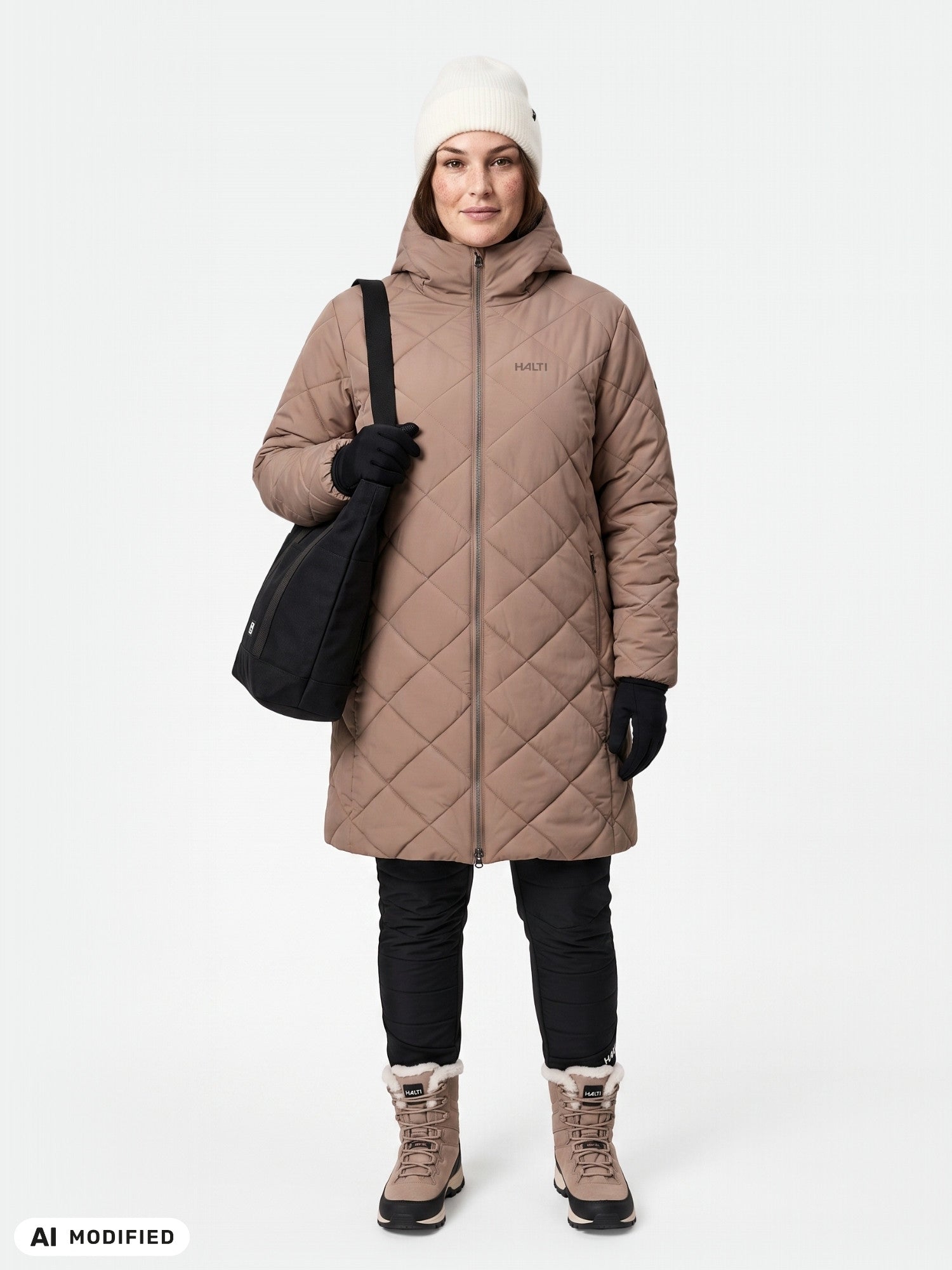 Person in a Halti Haapa Quilted Coat Jacket Women’s Plus, black gloves, white knit hat, black bag, and winter boots.