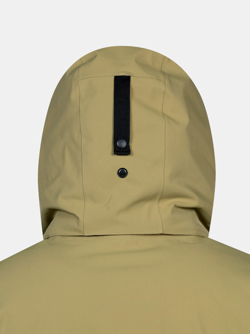 Halti Kallio DX Parka Men’s in khaki, back view with black strap and snap button detail at the center.